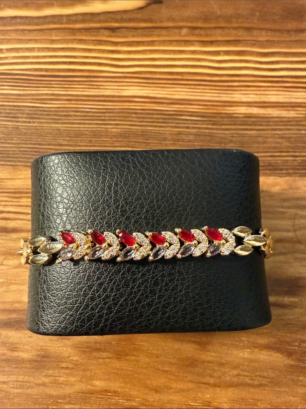 Gold-Tone Bracelet with Red Gem Leaf Accents